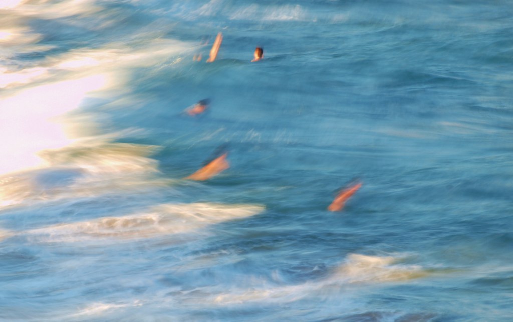 Blurred swimmers in action